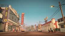 A view of the empty main street of Still Creek with the Hotel and the Bowling