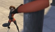 Elastigirl using her elasticity to turn a manhole cover into a weapon.