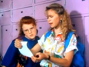 Tessa reading a note to Dorothy