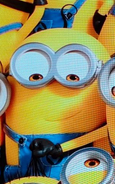 Two eyed short minion with a tiny curl of hair.
