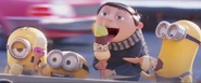 Gru eating ice cream with the Minions.