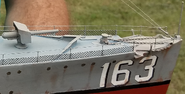 Detail of the bow of Taylor's Walker model, note the railing details, a line on top and middle with a mesh below the middle line. The deck where the anchors lay and the fore gun. portion of photo by (C) Donald Johnson used with permission.