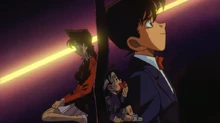 Conan contacts Ran (using his tie to mimic his Shinichi voice) and tells her that she must find and disarm the bomb