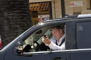 Isaak Sirko shoots through a Sadie's Donuts' window, attempting to kill Dexter