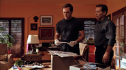 Dexter breaks into Maria's house, finds warrants for his and Deb's phones