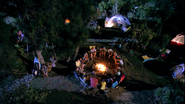 Boys and fathers around a campfire