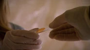 Dexter hands Lumen Cole's blood slide, after killing him