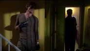 Dexter prepares to capture Trinity in Kyle's apartment