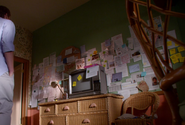 Wall with information about rapists in Lumen's motel room