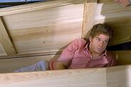 Dexter hides in a coffin made by Arthur