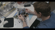 Dexter looking over a victim's photo