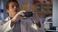Dex with camera 507.png (1.01 MB) Dexter sneaks a photo of Cole
