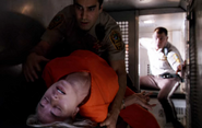 While being transported to jail, Hannah has a seizure