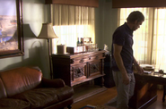 Dexter looks for Ellen's ring in Miguel's study