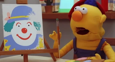 Yellow Guy painting a picture of a clown