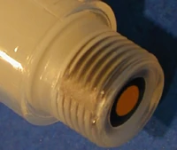 Close up of the rubber stopper of an insulin pen cartridge.   from it means inserting the  needle into this stopper, just as is done on the rubber stopper of an insulin vial.