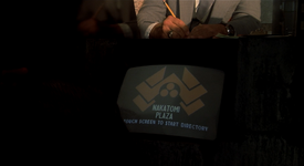 The Nakatomi Plaza logo, seen on the welcome directory in the lobby and on Holly's paperwork.