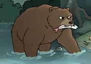 Ursula in bear form, holding a fish.
