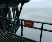 A sign atop the lighthouse, warning against danger of falling.