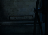 A sign for Greasely Boulevard, close-up.