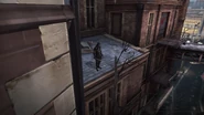 The fourth assassin standing on a roof.