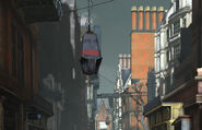 A loudspeaker hangs above a city street, with another in the distance.