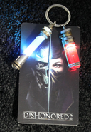 Light up keychain with Piero's Spiritual Remedy and Sokolov's Elixir, given away at the Dishonored booth of E3 2016.