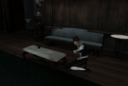 Melissa cowering by a table.