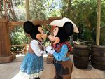 Mickey and Minnie kiss at Disneyland.
