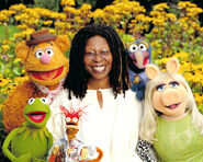 Whoopi with the Muppets in a publicity photo for It's a Very Merry Muppet Christmas Movie.