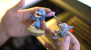Stitch's figure next to a prototype model of Yoda's figure.