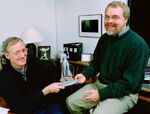 John Musker and Ron Clements holding a Captain Amelia sculpture for Treasure Planet.