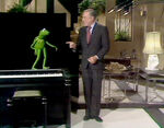 Kermit gets a dance lesson from Gene Kelly.