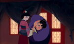 The matchmaker looks Mulan over carefully.