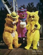 An orange Scat Cat with two of his bandmates at one of the Disney parks