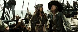Captains Jack and Barbossa arguing aboard the Black Pearl.