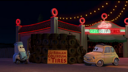 Guido and Luigi building a model of the Coliseum made out of tires.