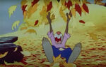 Brer Rabbit laughing while throwing leaves up