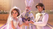 Eugene and Rapunzel exchange their wedding rings as the priest pronounces the couple husband and wife