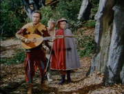 Midge, Allan-a-Dale, and Maid Marian confronted by Robin, Little John, and Will Scarlet as Allan-a-Dale sings