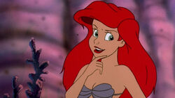 Ariel, a 18-year-old mermaid (later woman) with red short hair and blue  eyes who only wears purple bra. She lives in between underwater and town.  She is daughter of Sea King and