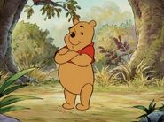 Pooh folds his arms.