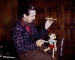 Walt Disney playing with a Pinocchio marionette to promote the film.