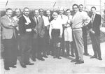 A 1965 group photograph of Disney artists in the WED parking lot in Glendale, California, from left to right: Herbert Ryman, Ken O'Brien, Collin Campbell, Marc Davis, Al Bertino, Wathel Rogers, Mary Blair, T. Hee, Blaine Gibson, X. Atencio, Claude Coats, and Yale Gracey.