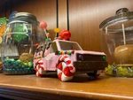 Trolley Treats A truck is remodeled to resemble candy and gingerbread. The rocket has a stick protruding out of it's fuselage, like a lollipop.