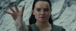 Rey smiles while lifting rocks