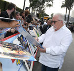 John Ratzenberger signing autographs at the premiere of Toy Story 4 in June 2019.