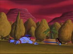 Furious, Jafar throws Genie to the ground, knocking him unconscious