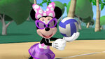 Minnie is playing Volleyball.