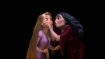 Mother Gothel squeezing Rapunzel's cheeks.